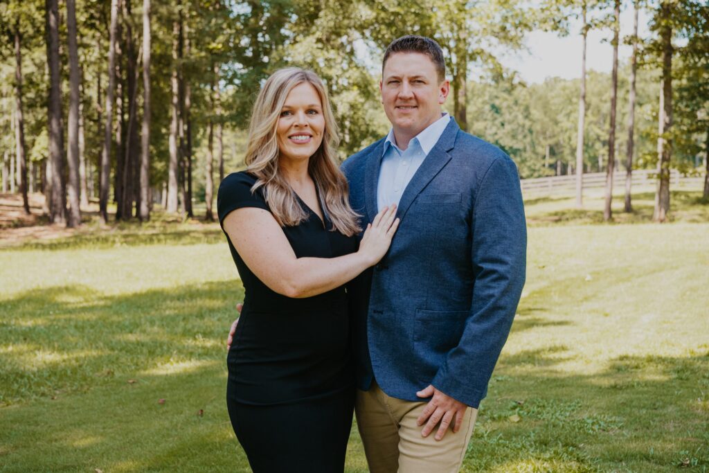 Arrio and Kelsey Granum outdoors near Fort Benning, listing agents for military sellers with PCS orders